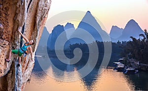 Bright Image of Young Rock Climber Sunrise karst Mountains in China and River