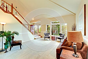 Bright ivory living room with high vaulted ceiling and french wi