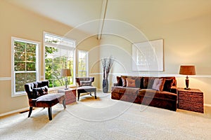 Bright ivory living room with high vaulted ceiling and french wi