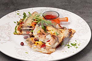 Bright and juicy Mexican quesadilla with hot sauce