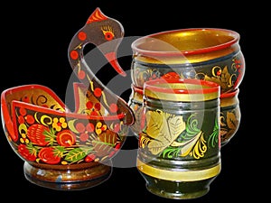 Bright Khokhloma kitchen utensils isolated on a black background. Khokhloma is an ancient Russian folk craft of the 17 century.