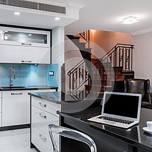 Bright kitchen interior with black worktops