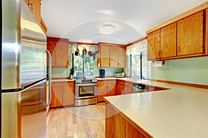 Bright kitchen with light brown cabinets and wooden counter tops.