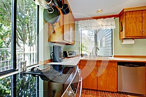 Bright kitchen with light brown cabinets and wooden counter tops.