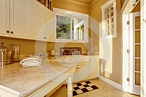 Bright kitchen room area with white cabinets, granite counter top