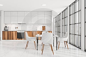 Bright kitchen room interior with table and four chairs