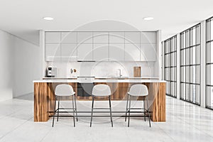 Bright kitchen room interior with table and three bar stool