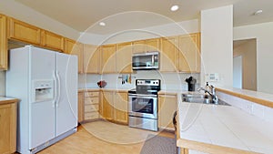 Bright kitchen room with light wood cabinets.