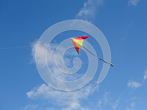 Bright kite against the blue sky. Sunny day