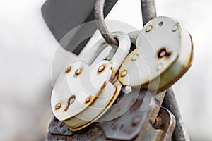 The bright large metal padlocks in the form of hearts and with rusty from time metal enshrined. The concept of divorce