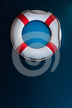 Bright Life Buoy in dark background. Personal life support flotation safety device for swimmers, passengers or marine personnel