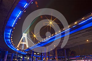 Bright lights under urban overpass photo