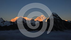 Bright lit Mt Everest at sunset, sea of fog