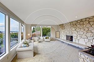 Bright living room with rock wall trim and fireplace