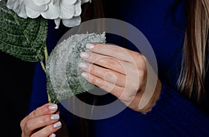 Bright manicure on flowers with a dark background