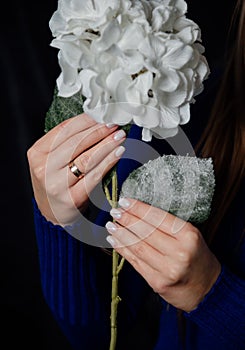 Bright manicure on flowers with a dark background