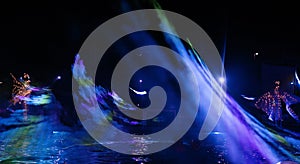 bright men dancing while dj set and lights show