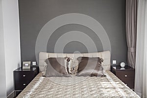 Bright, modern bedroom with beige bedspread.