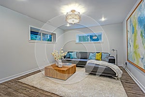 Bright modern family room interior with blue pillows on the sofa.