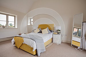 Bright modern furnished bedroom in yellow and white