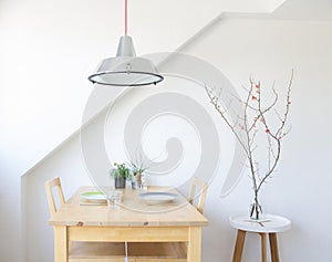 Bright, modern kitchen with table, plates, glasses