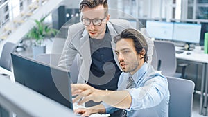 In Bright Modern Office: Handsome Office Worker Sitting and Working at His Desktop Computer, Discu