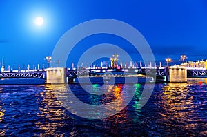 Bright moon over the Troitskiy  Bridge over the Neva River with night illumination. Saint-Petersburg. Russia