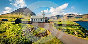 Bright morning view of Vidareidi Kirkja. Panoramic outdoor scene of Vidoy island. Attractive summer view of Faroe Islands, Kingdom