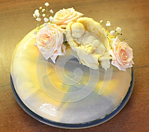 Bright mousse cake with mirror glaze. Decored by chocolate ange and roses in pastel colors