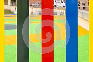 Bright multi-colored fence of a playground for children close-up