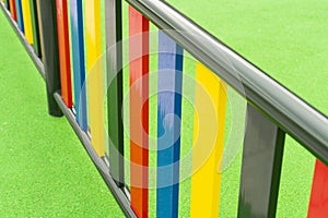 Bright multi-colored fence of a playground for children close-up
