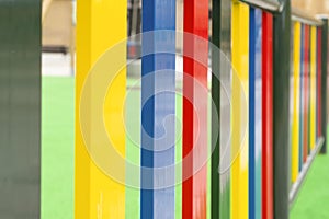 Bright multi-colored fence of a playground for children close-up