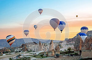 Bright multi-colored hot air balloons flying in sunsrise sky Cappadocia, Turkey