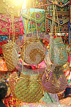 Bright national Indian colored bags are sold in the market of bazaars in India, Goa. Souvenirs Gifts India. Hand embroidery in