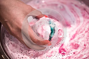 Bright natural fizzy bath bomb dissolves in the hands