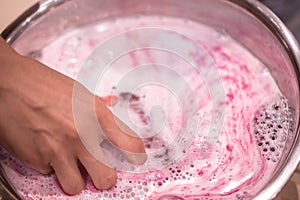 Bright natural fizzy bath bomb dissolves in the hands