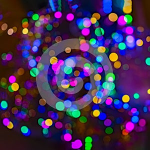 Bright neon sparkle, bokeh lights. Selective focus. Defocused lights. Abstract holiday background