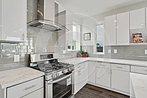 Bright and neutral kitchen with glossy gray subway tile backsplash