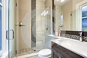 Bright new bathroom interior with glass walk in shower