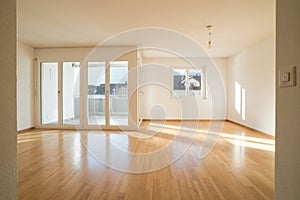 Bright new living room in an empty apartment with french doors and parquet wooden floors