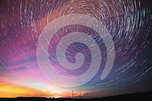 Bright Night Starry Sky. Soft Blue-orange-pink Colours. Amazing Star Trails On Night Sky Background. Trails Of Stars