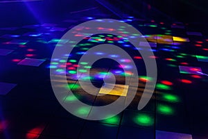 Bright nightclub red, green, purple, white, pink, blue laser lights cutting through smoke machine smoke photo