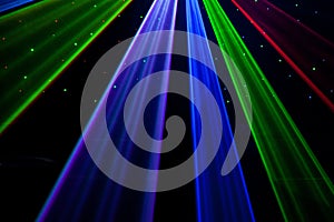 Bright nightclub red, green, purple, white, pink, blue laser lights cutting through smoke machine smoke making light patterns