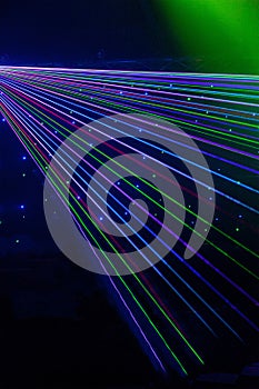 Bright nightclub red, green, purple, white, pink, blue laser lights cutting through smoke machine smoke making light patterns