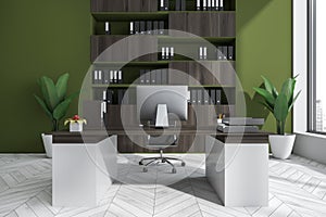 Bright office room interior with desk, comfortable armchair, desktop, window