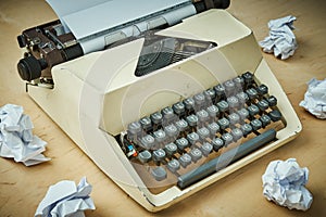 Bright old typewriter with gray keys and pieces of paper