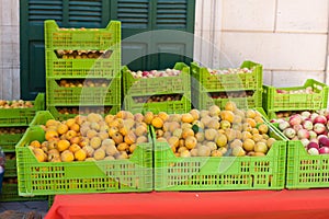 Bright orange apricots in boxes for sale on Apricot Fair in Porreres, Mallorca photo