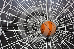 Bright orange basketball ball in a broken window