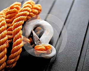 Orange nylon braided rope with metal tow hook.