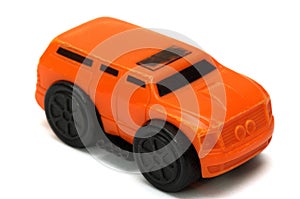 A bright orange colored toy van MPV multi purpose vehicle car against a white backdrop photo